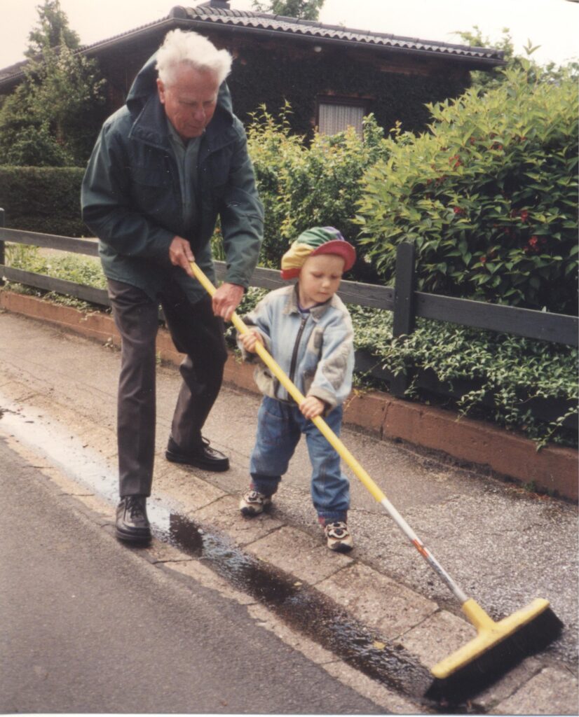 Jürgen und Jonathan Junge fegen die Straße in Osterlükken, Harrislee, 1999
